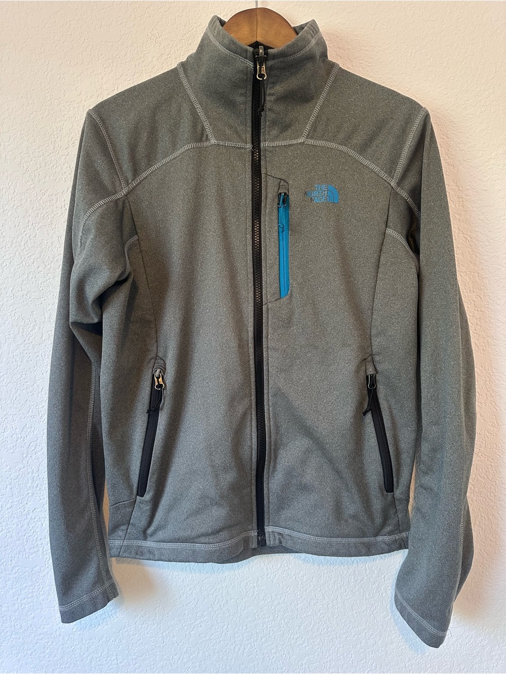 The North Face Men's Gray Softshell Jacket with Blue Zip Accent